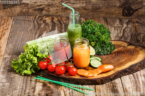 Image of The bottles with fresh vegetable juices on wooden table