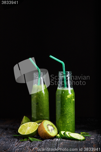 Image of The bottles with fresh vegetable juices on wooden table