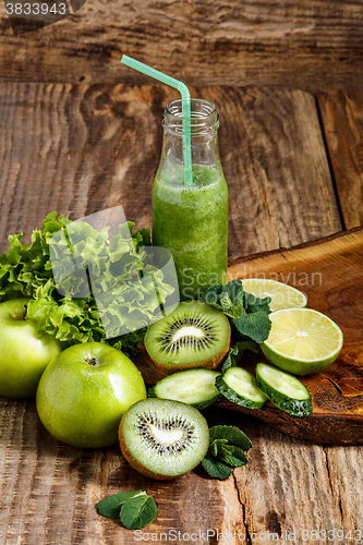Image of The bottles with fresh vegetable juices on wooden table