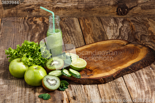 Image of The bottles with fresh vegetable juices on wooden table