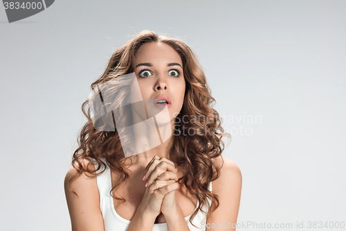 Image of Portrait of young woman with shocked facial expression