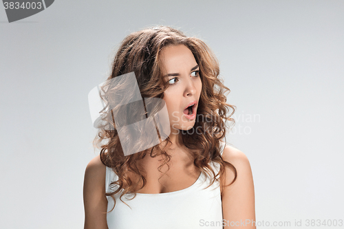 Image of Portrait of young woman with shocked facial expression