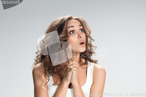 Image of Portrait of young woman with shocked facial expression