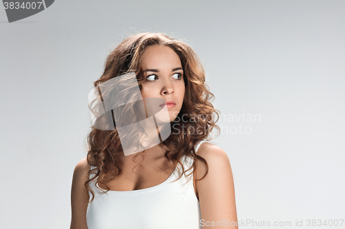 Image of Portrait of young woman with shocked facial expression