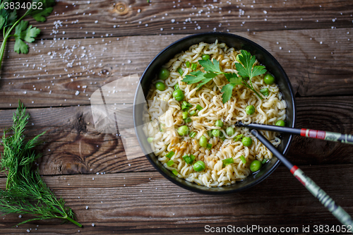 Image of Chow Mein: fried noodles with chicken and vegetables close-up. horizontal view from above