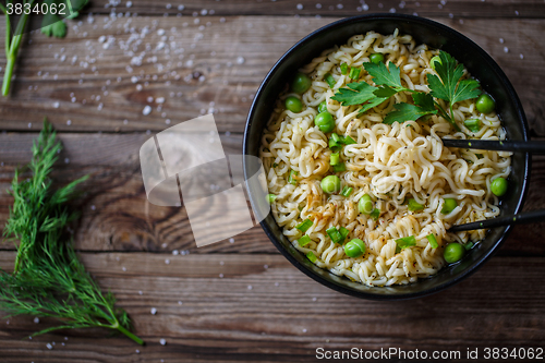 Image of Chow Mein: fried noodles with chicken and vegetables close-up. horizontal view from above