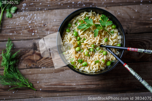 Image of Chow Mein: fried noodles with chicken and vegetables close-up. horizontal view from above