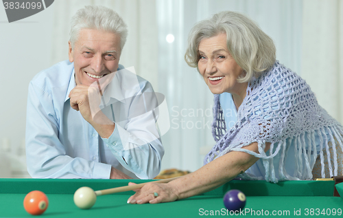 Image of old couple playing billiard