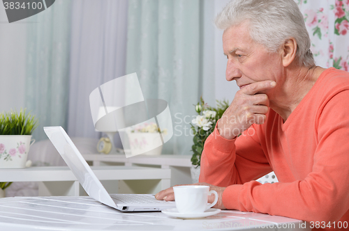 Image of senior man  in the kitchen