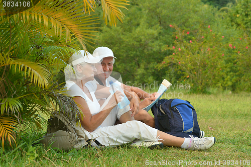 Image of elderly couple rest at tropical resort