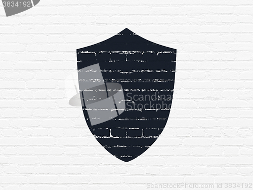 Image of Protection concept: Shield on wall background