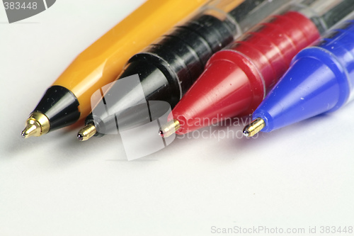 Image of four different coloured ball point pens