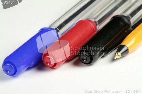 Image of four different coloured ball point pens