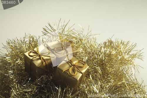 Image of gold present box decorations with golden tinsel