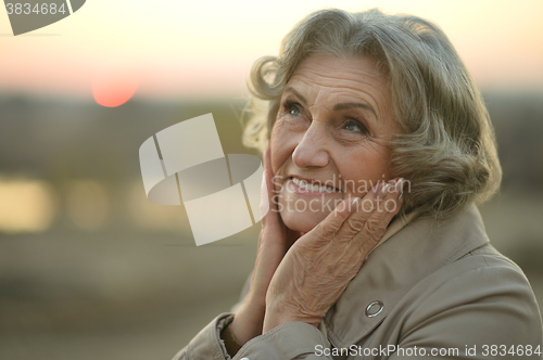 Image of senior woman in  autumn park