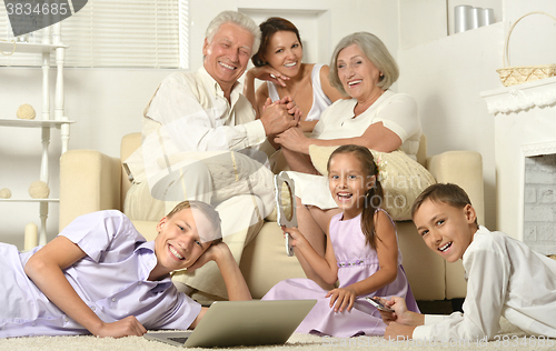 Image of Happy family with kids with laptop