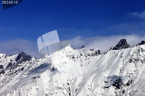 Image of View on snowy mountains in haze at sunny day