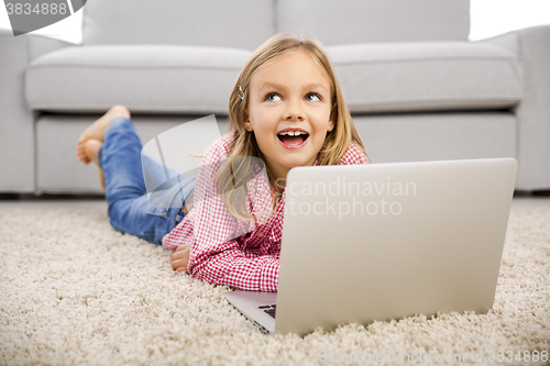 Image of Little girl working with a laptop