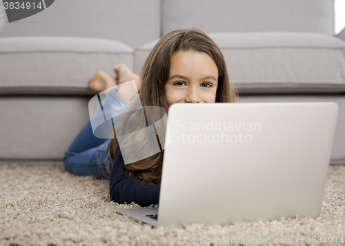 Image of Little girl working with a laptop