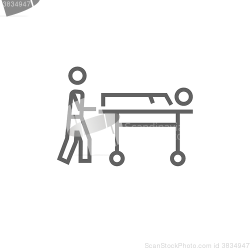 Image of Man pushing stretchers line icon.