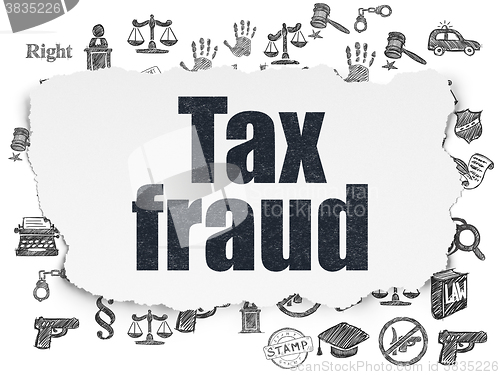 Image of Law concept: Tax Fraud on Torn Paper background