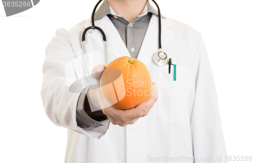 Image of Nutritionist doctor, giving an orange, isolated