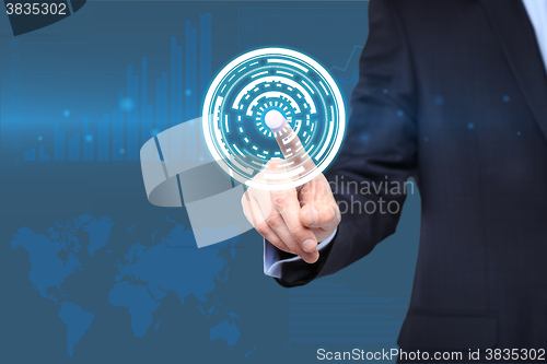 Image of  technology and internet concept - businessman pressing button with mechanism icon on virtual screens