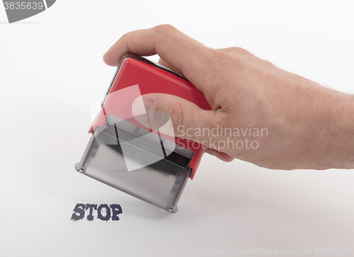 Image of Plastic stamp in hand, isolated