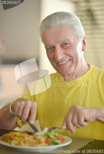 Image of Happy Senior man having breakfast