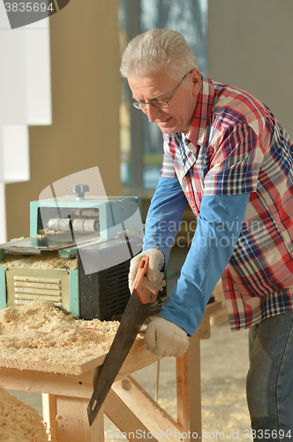 Image of Senior man  repairing in the room