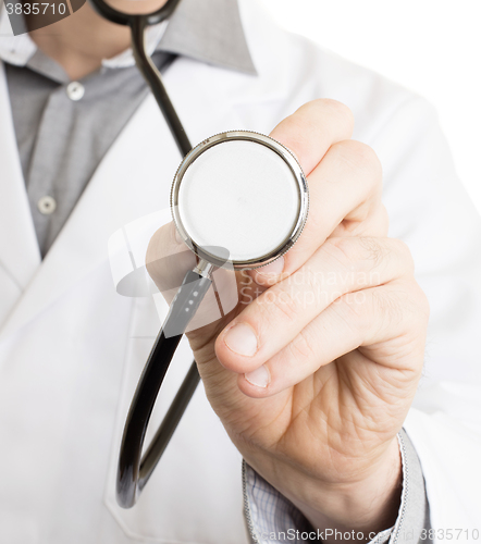 Image of Close up of a Doctor\'s hand, holding a stethoscope 