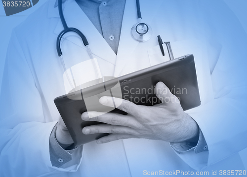 Image of Doctor using a digital tablet, medical blue