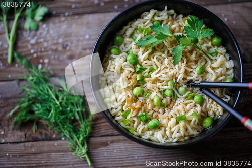 Image of Chow Mein: fried noodles with chicken and vegetables close-up. horizontal view from above