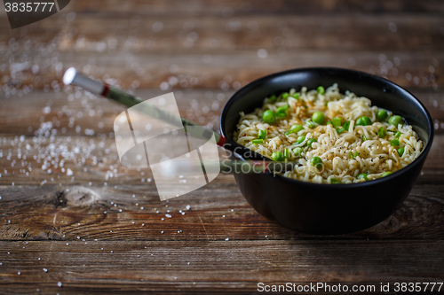 Image of Bowl of noodles with fresh peas and chopped onion.