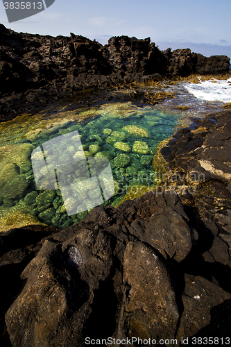 Image of rock beach  water boat yacht   spain