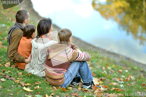 Image of  smiling family relaxing 