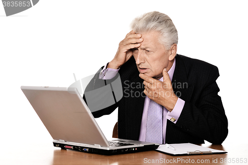 Image of Old businessman working