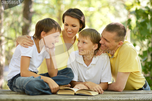 Image of Family of four reading 