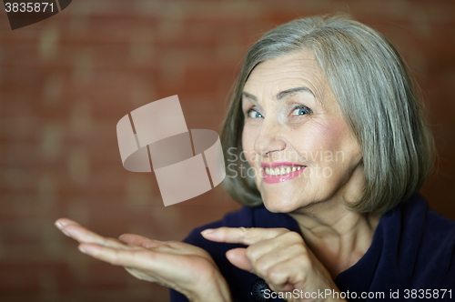 Image of Older woman pointing