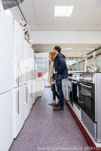 Image of Couple Buying Refrigerator In Hypermarket