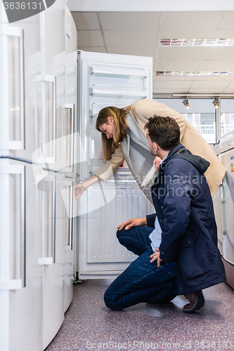 Image of Couple Buying Domestic Refrigerator In Hypermarket