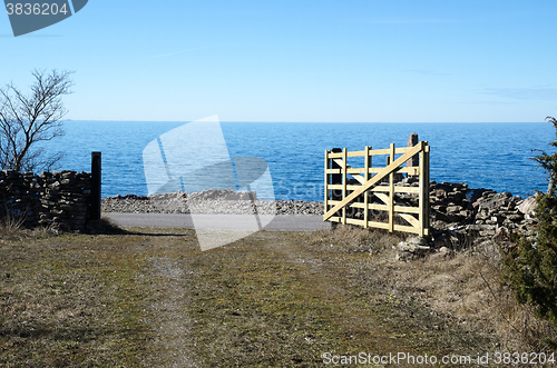 Image of Open traditional wooden gate by the coast