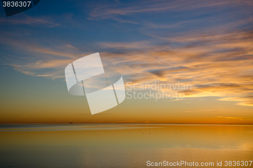 Image of Colorful sunset by an absolutely calm water