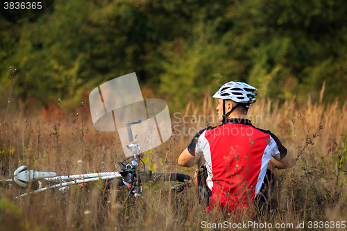 Image of man repairing his mountain bike