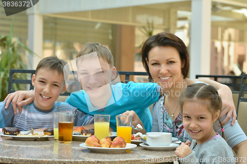Image of Mother and children  at breakfast