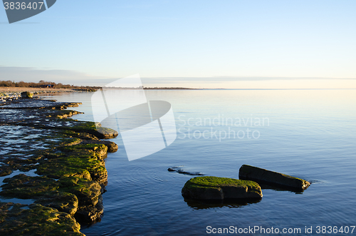 Image of Flat rock coast with calm water 