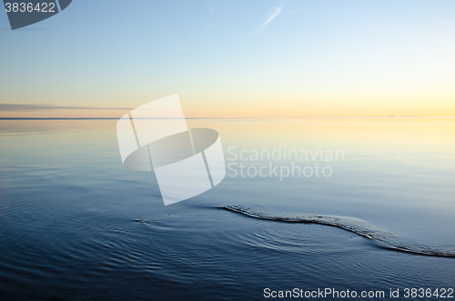 Image of Smooth water and colorful sky