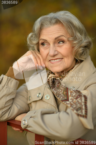 Image of senior woman in  autumn park