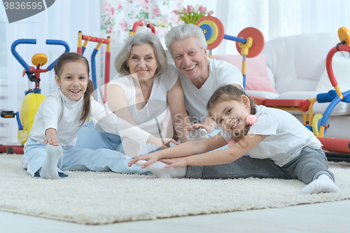 Image of grandparents  and  granddaughters doing exercise