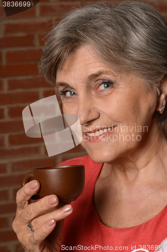 Image of  aged woman drinking 